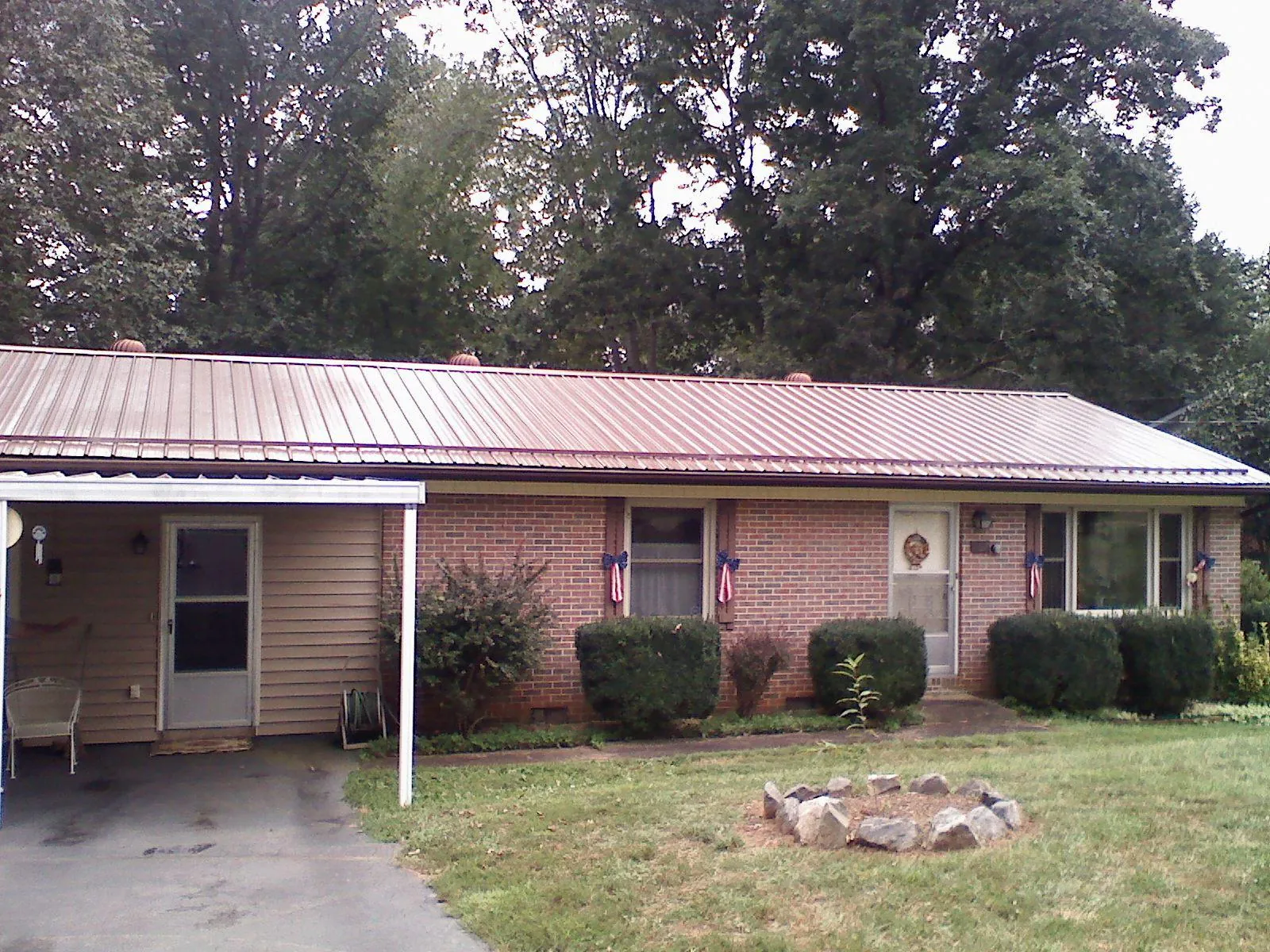 Bronze metal roof and carport on a brick ranch home — Roof Repair work by our crew in Murchison